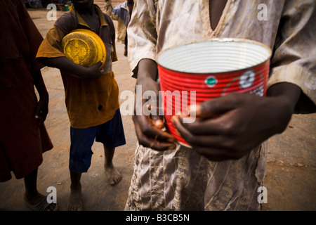 Young students from a koranic school beg on the streets of Koungheul, Senegal Stock Photo