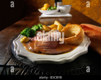 Traditional British roast dinner with roast beef, roast potatoes, yorkshire puddings. 21 days hung Stock Photo