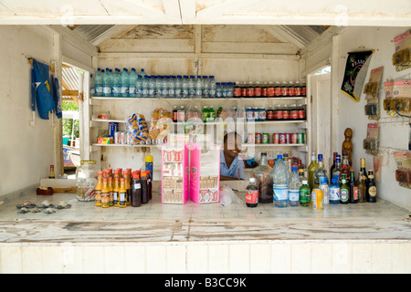 A young St Lucian boy sells drinks in a bar stall, Marigot Bay, St Lucia, 'West Indies', Caribbean Stock Photo