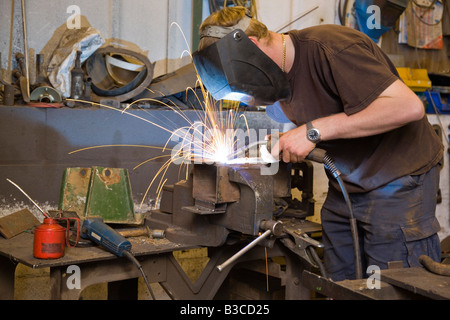 A man welding in a workshop Stock Photo