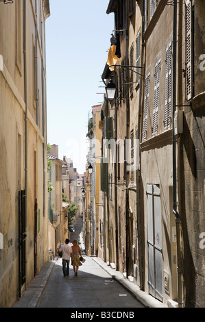 Young couple walking down a typical street in the Panier district above the Vieux Port, Marseille, Cote d'Azur, France Stock Photo