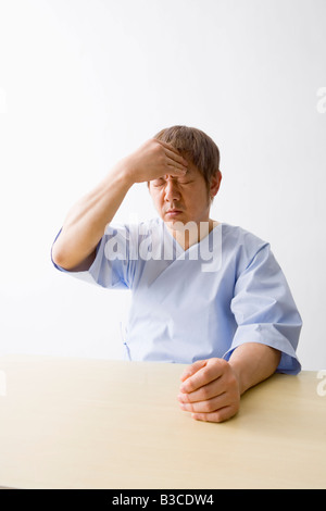 Mid adult man suffering from headache Stock Photo