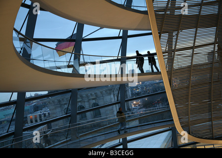 Tourists inside the dome of the Reichstag building in Berlin, Germany Stock Photo