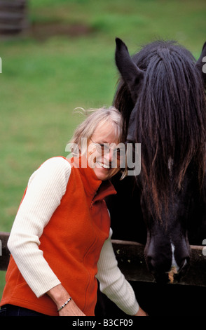 Farm Stay Guest cuddling a Shire Horse Kangaroo Valley New South Wales Australia Stock Photo