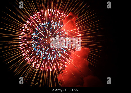 Fireworks explode with a puff of smoke over Lake Suwa Nagano Japan Stock Photo