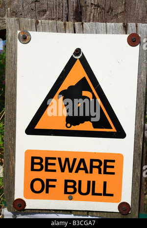 A warning sign stating 'BEWARE OF BULL'. Stock Photo