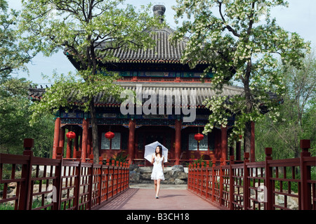 China, Beijing. Old Summer Palace - a young girl at a pavilion (MR). Stock Photo