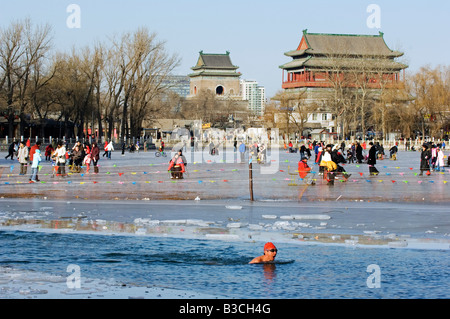 China, Beijing, Houhai area. Winter swimming in front of The Drum and Bell towers. Stock Photo