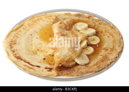 Fresh Banana And Maple Syrup Pancake Isolated Against A White Background With A Clipping Path And No People Stock Photo