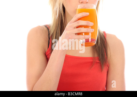 Young Woman Starting The New Day Drinking A Glass Of Healthy Carrot Juice Isolated Against A white Background With A Clipping Path Stock Photo