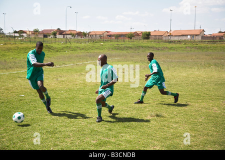 13MA-003 © Monkeyapple  aFRIKA Collection  Great Stock ! Team playing soccer on green field Stock Photo