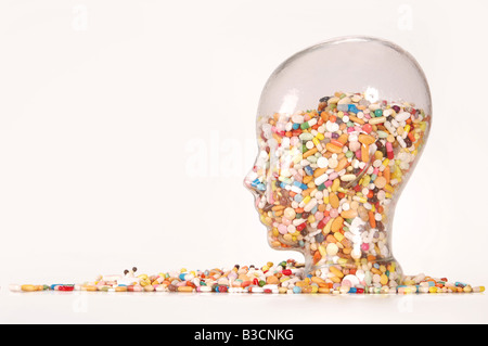 Collection of Pills in Glass, head-shaped Stock Photo