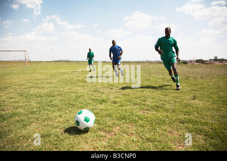 13MA-005 © Monkeyapple  aFRIKA Collection  Great Stock ! Team playing soccer on green field Stock Photo