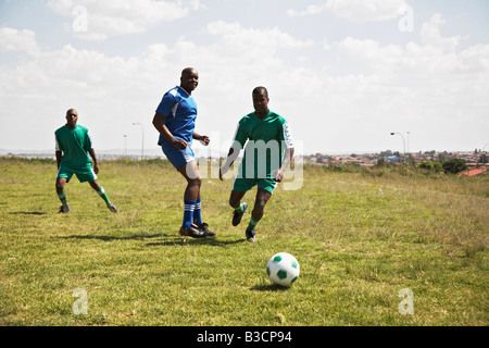 13MA-004 © Monkeyapple  aFRIKA Collection  Great Stock ! Team playing soccer on green field Stock Photo