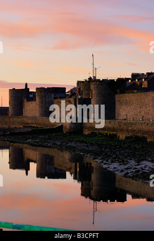 The outer walls of Caernarfon castle on the coast of North Wales in late evening sunshine Stock Photo