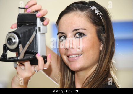 Brunette girl with an old Kodak Junior 1 camera which used 620 roll film Stock Photo