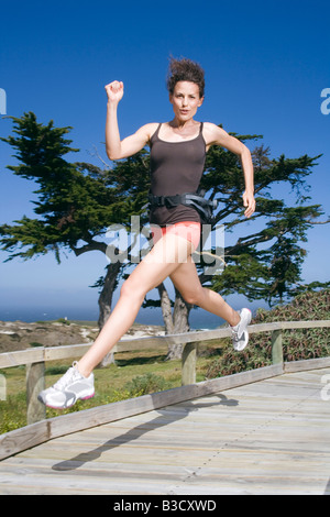 South Africa, Cape Town, Young woman jumping, portrait Stock Photo