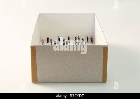 Business men figurines standing in cardboard box Stock Photo