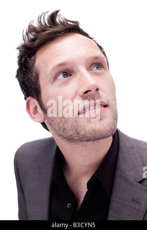 Young man looking up, portrait, close-up Stock Photo