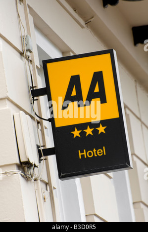 Illuminated yellow and black three star AA rating sign on the side of a hotel in Weymouth in Dorset Stock Photo