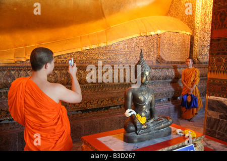 a monk taking a souvenir picture Stock Photo