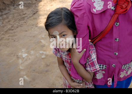 burmese young girl with Traditional face painting, people make face painting by using a natural spicery called 'Thanakha' Stock Photo