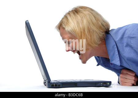 Businesswoman screaming at her lap top Stock Photo
