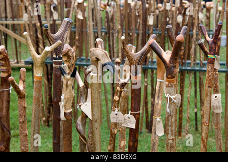 A display of hand crafted walking sticks and canes at an agricultural show Stock Photo