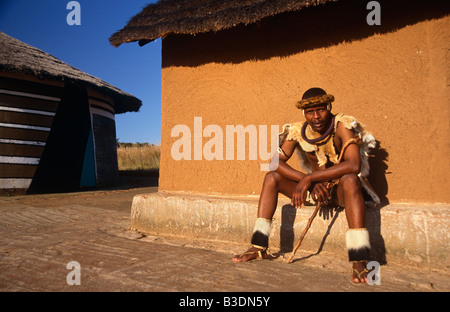 Ndebele tribesman in traditional tribal costume outside mud hut, portrait, South Africa, Africa Stock Photo