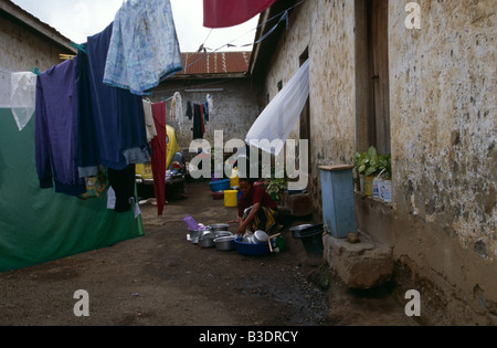 Woman performing daily chores in backyard, Tanzania Stock Photo