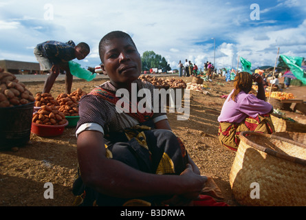 Women market traders sitting on ground with produce, Uganda Stock Photo