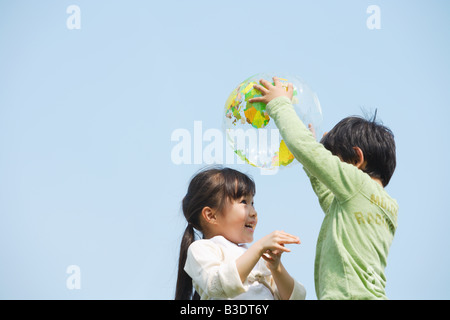 Children playing together with a ball Stock Photo