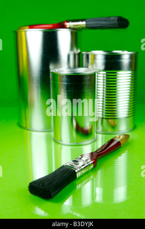 Paints and brushes isolated against a green background Stock Photo
