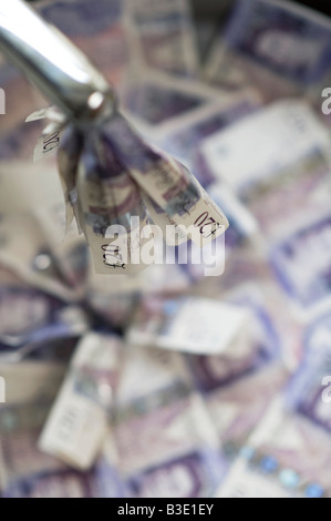 Pouring money down the drain concept Stock Photo