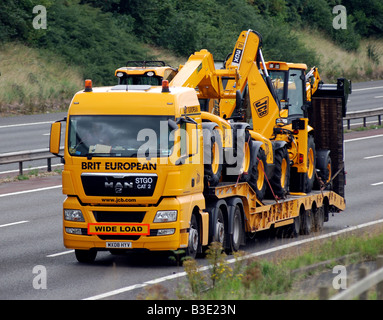 New JCB vehicles transported on M40 motorway, England, UK Stock Photo