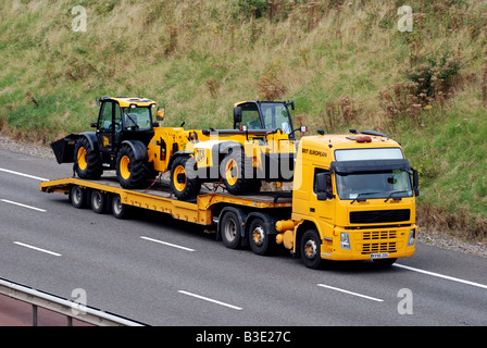 New JCB vehicles transported on M40 motorway England UK Stock Photo