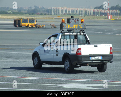 vehicle with stop follow me sign on airport tarmac Stock Photo