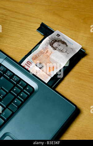 Ten pound note in open disk drive of laptop computer Stock Photo - Alamy