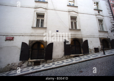 The steep cobblestone street of Zamecka in Prague Czech Republic contrast with the level building along the street Stock Photo