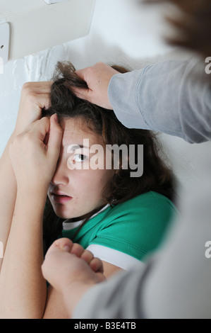 A shcool girl being threatened and bullied at school or online Stock Photo