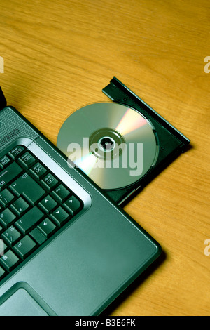 Compact disk in open drive of laptop computer Stock Photo