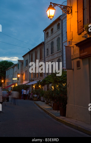 Street and cafe scene at night in Arles France Stock Photo