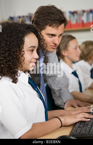 Teacher and girl with computer Stock Photo