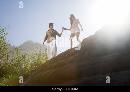 Young couple walking on rocks Stock Photo