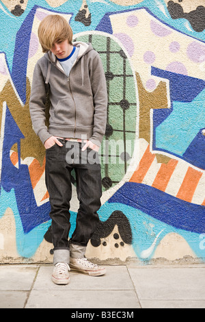 White teenage boy in jeans and a sweat top sitting by his open Stock ...