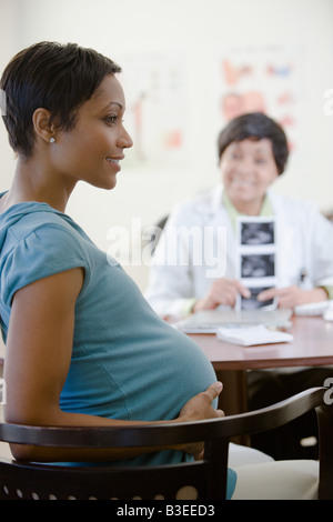 A pregnant woman in a doctors office Stock Photo