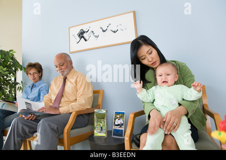 Patients waiting in a doctors office Stock Photo