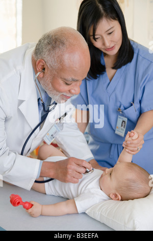A doctor and nurse examining a baby Stock Photo