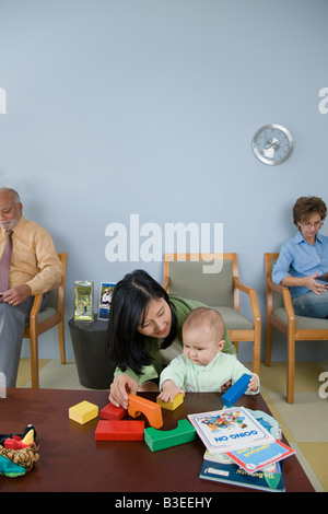 Patients waiting in a doctors office Stock Photo