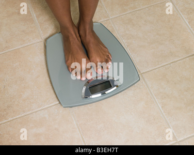 Feet of woman on scales Stock Photo
